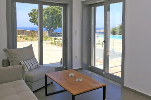 a living room with a couch and a table at Harma Villas in Andros