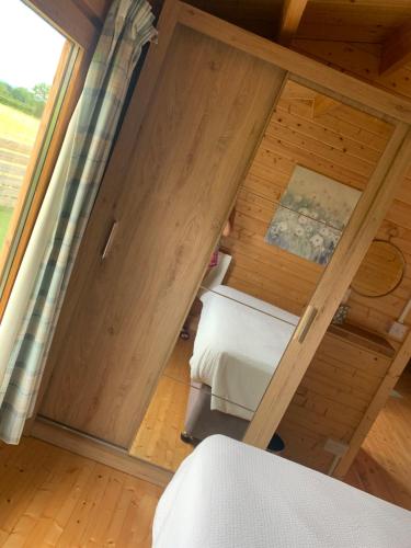 a small room with a bed and a window at Keepers Lodges in Broadway