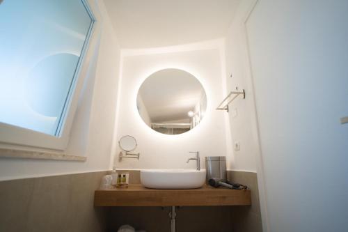 a bathroom with a sink and a mirror at B&B La Ferula in Altamura