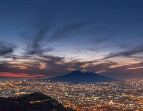 a view of a city at night with a mountain at HOTEL VALLEVERDE in Corbara