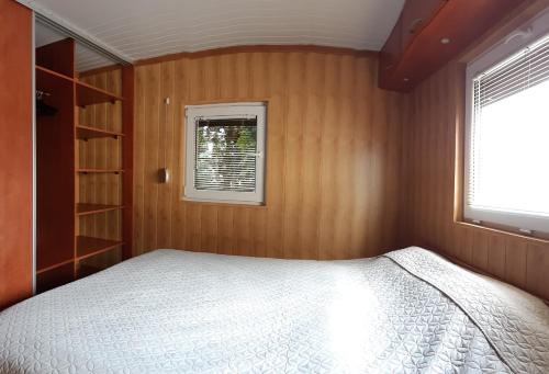 a small bedroom with a bed and a window at Twój wypoczynek in Augustów