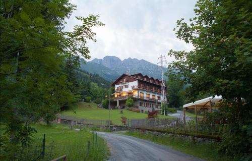 a large house on the side of a road at Albergo Ristorante Scanapà in Castione della Presolana