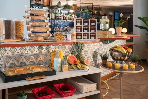 a bakery with bread and other food items on shelves at Novotel Suites Nice Airport in Nice