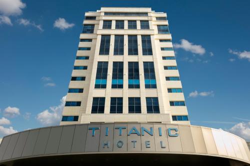 a tall white building with the name of a hotel at Titanic Business Kartal in Istanbul