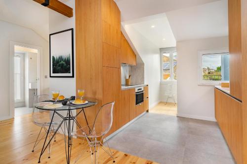 a kitchen with a table and chairs in a room at Lisbon Prime Aparts - BeatoHub in Lisbon