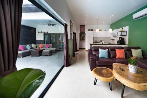 a living room with a couch and a table at Majestic by Korawan in Pattaya South