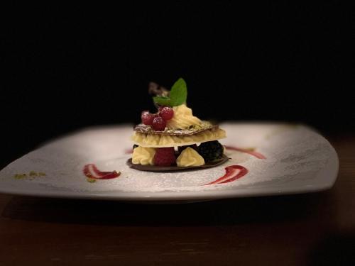 a dessert on a white plate on a table at Dolomit Boutique Hotel in La Villa