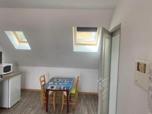 une petite cuisine avec une table et des chaises dans une pièce dans l'établissement Studio Vieille Ville, à Boulogne-sur-Mer