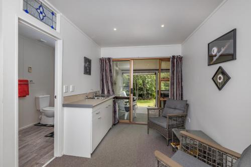 a kitchen with a sink and a toilet in a room at Havenbrooke - Kerikeri Holiday Home in Kerikeri