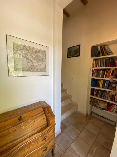 a room with a staircase and a book shelf with books at B&B La Fucinaia Pet Friendly Adults only in Campiglia Marittima