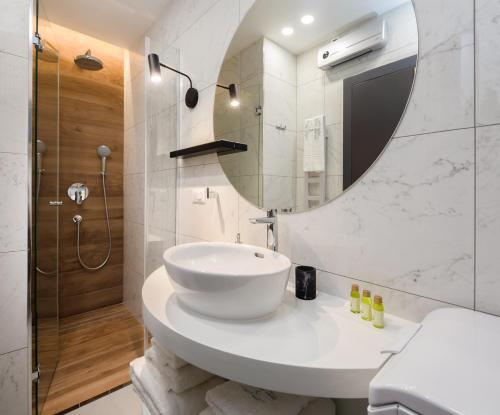 a bathroom with a white sink and a mirror at V Luxury Apartment in Split