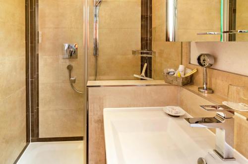a bathroom with a shower and a sink and a tub at Ferienwohnung Wolf Überlingen in Überlingen