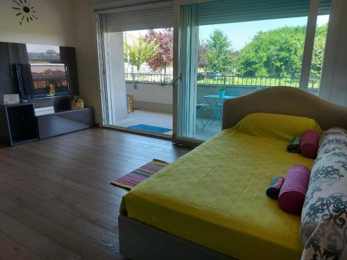 a bedroom with a bed and a large sliding glass door at Bnbook - Metropolitan Expo Flat in Rho