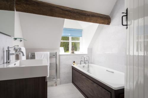 A bathroom at Rose Barn Cotswolds with Hot Tub