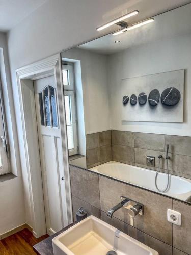 a bathroom with a sink and a large mirror at Villa Zwölf in Soltau
