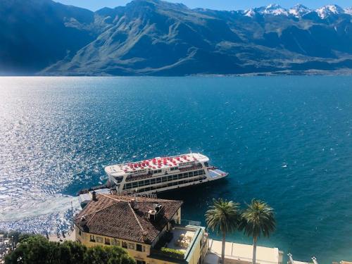 a cruise ship in the middle of a large body of water at Hotel Castell - Montagnoli Group in Limone sul Garda