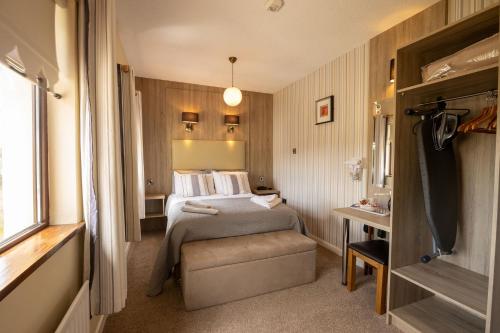 a bedroom with a bed and a chair in a room at Station House Bed & Breakfast in Ennistymon