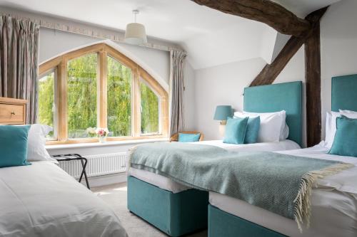 A bed or beds in a room at Rose Barn Cotswolds with Hot Tub