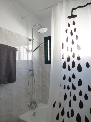a bathroom with a shower with a shower curtain at El Pasadizo - The secret passage-Puerto del Carmen in Puerto del Carmen