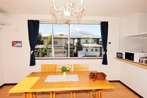 a dining room with a table and a large window at Private House Sakura in Fujikawaguchiko