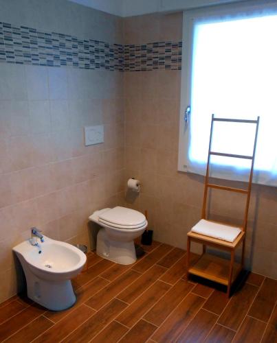 a bathroom with a toilet and a sink at VCE House in Tessera