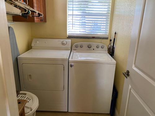 a white washer and dryer in a small room at Atlantic Shores Vacation Villas in Palm Beach Shores