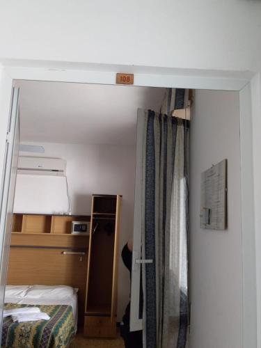 Un ou plusieurs lits dans un hébergement de l'établissement Hotel Gino