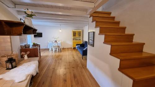 a living room with stairs and a dining room at Salvia in Pićan