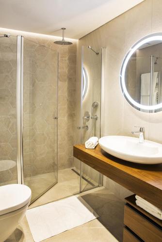 a bathroom with a sink and a shower at Garlon Residence in Istanbul