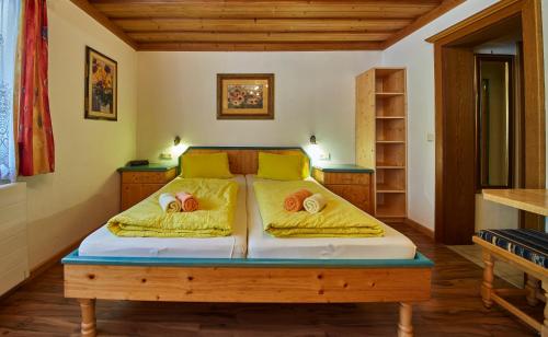 a bedroom with a bed with two pillows on it at Appartements Taxach in Saalbach-Hinterglemm