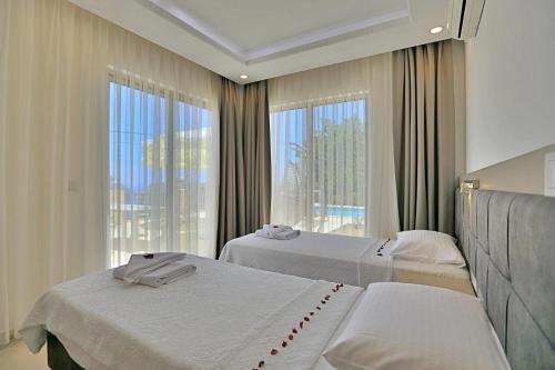 Ένα ή περισσότερα κρεβάτια σε δωμάτιο στο Villa Asya