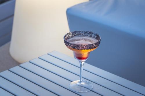 a drink in a wine glass sitting on a table at Hotel & Spa Relais Freedom Club in Massa Lubrense