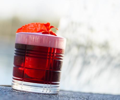 a red drink with a cherry on top at Hotel & Spa Relais Freedom Club in Massa Lubrense