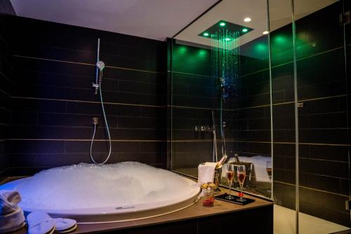 a bathroom with a bath tub with a shower at Felix Hotel in Valls