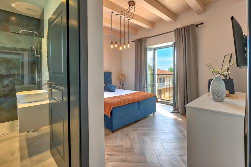 a bedroom with a bed and a balcony at Villa Vitassi in Pula