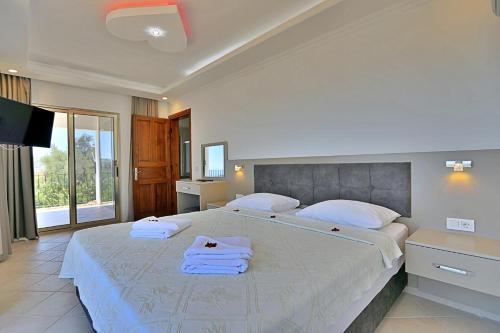 Ένα ή περισσότερα κρεβάτια σε δωμάτιο στο Villa Asya