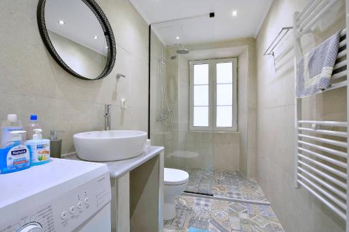 bagno con lavandino, servizi igienici e specchio di Sofias Flat a Città di Corfù