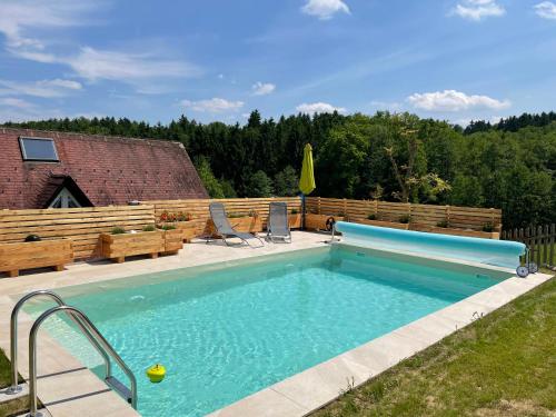 a swimming pool with a slide in a backyard at Ferienwohnung Fam. Lerch in Sankt Stefan ob Stainz