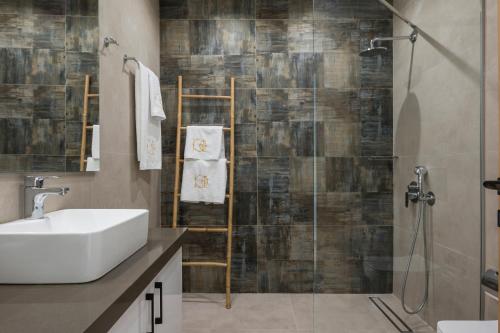 a bathroom with a sink and a shower at Kolymbari Sea Front Cozy Apartments in Kolymvari