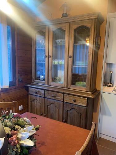 a large wooden hutch in a dining room with a table at PANORAMIC - Peu del Riu 502 - Vall d'Incles - Soldeu in Incles