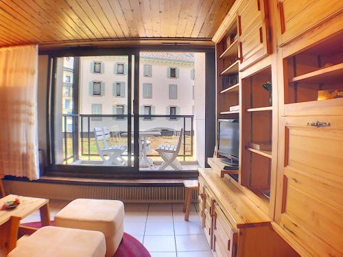 a room with a large window with a view of a building at Ladybird Inn in Chamonix