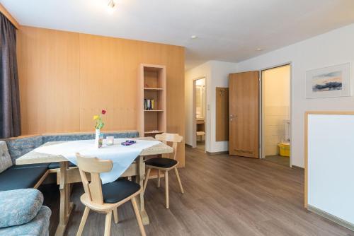 a living room with a table and a couch at Appartement Haus Zalim in Brand
