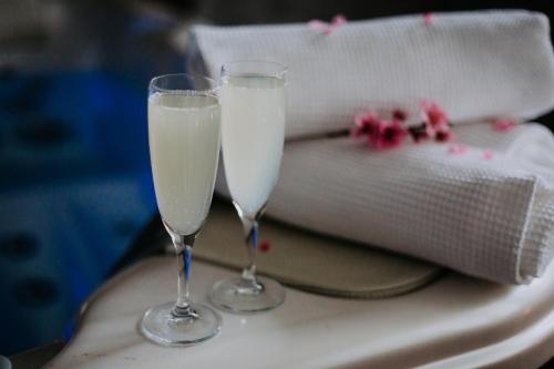 two glasses of white champagne sitting on a table at Willa Sepia SPA in Wisła