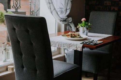 a dining room table with a plate of food on it at Willa Sepia SPA in Wisła