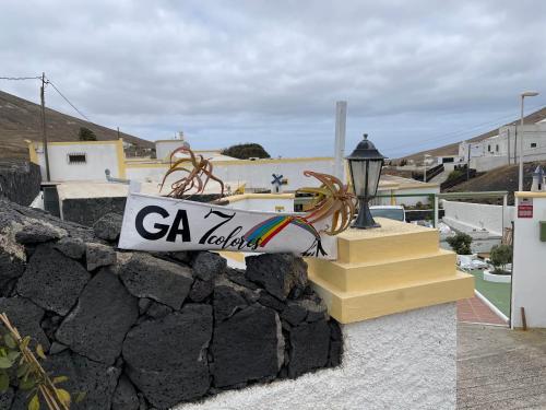 a sign on a wall next to some stairs at HOTELITO RURAL GA7COLORES only adult in Montaña Blanca