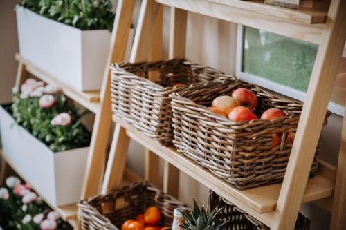 a bunch of baskets of fruits and vegetables on a shelf at Willa Sepia SPA in Wisła