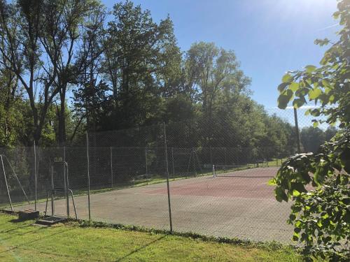 a tennis court with two tennis courts at Domaine du Plessis in Le Plessis-Luzarches