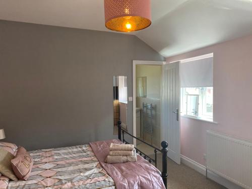 a bedroom with a bed and a window at Beautifully presented 6 bed 5 & a half bath house in Newcastle upon Tyne