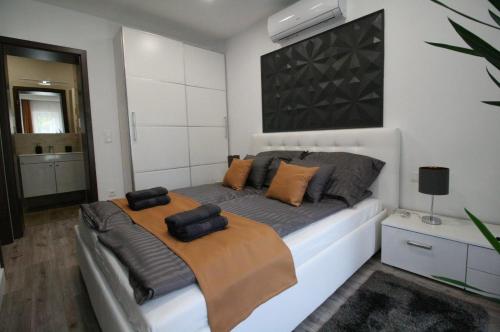 a bedroom with a bed with pillows on it at True Gem at the Airport by NW Apartments in Budapest