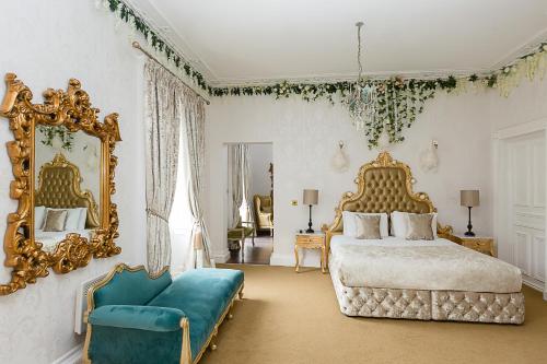 a bedroom with a bed and a mirror and a couch at RainHill Hall Hotel in Rainhull